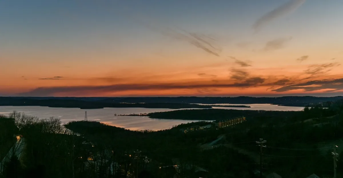 A breathtaking view of sunset over the lake, with silhouetted hills and the glassy, reflective water surface, creating a tranquil and inspiring natural scene perfect for evening relaxation or romantic moments after a day out.